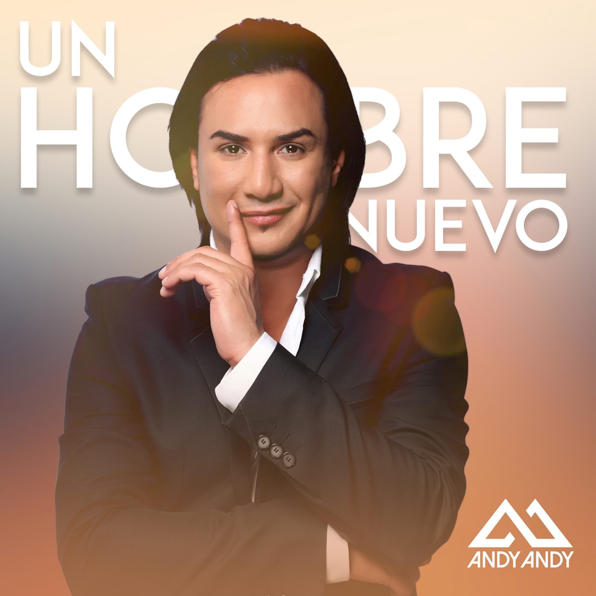 Cover art for Andy Andy's “Un Hombre Nuevo” — the singer in a dark suit, a finger raised to his lips, the title in large white letters and his AA logo