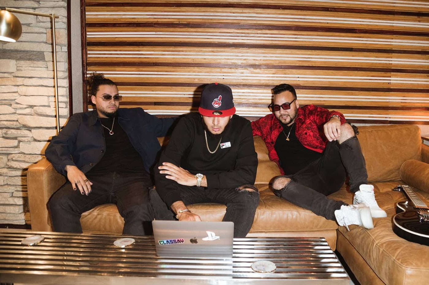 Three men on a leather couch at a laptop — LMP's Instagram post “THE REAL TRIO”, tagging Classay
