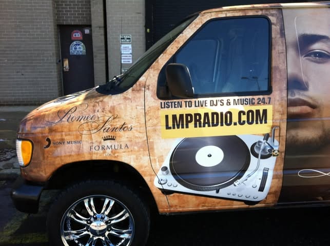 The LMP van wrapped in Fórmula, Vol. 1 art — “Romeo Santos”, the Sony Music and Fórmula logos, Romeo's face and LMPRADIO.COM on its side