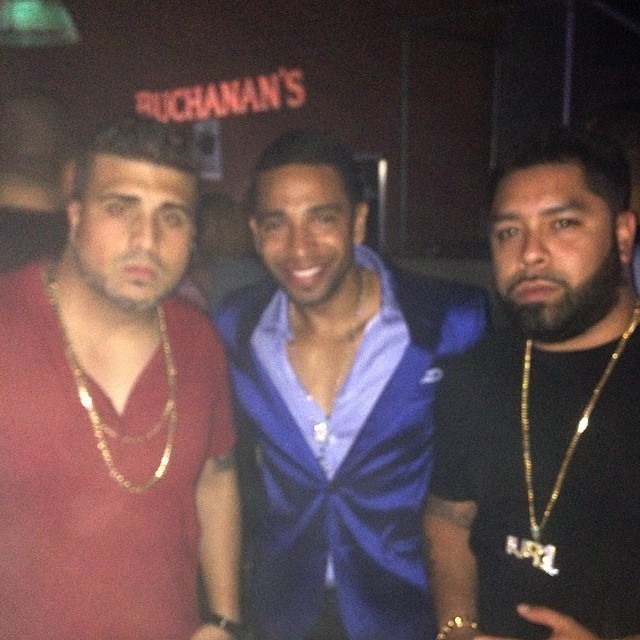 Henry Santos in a blue jacket between two members of the LMP team