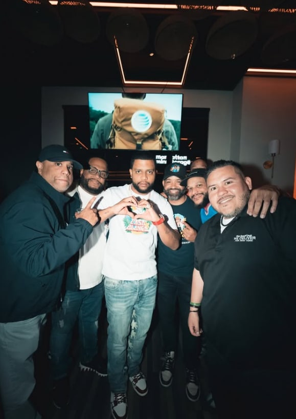 Jezzy El Chef making a heart sign with LMP DJs around him