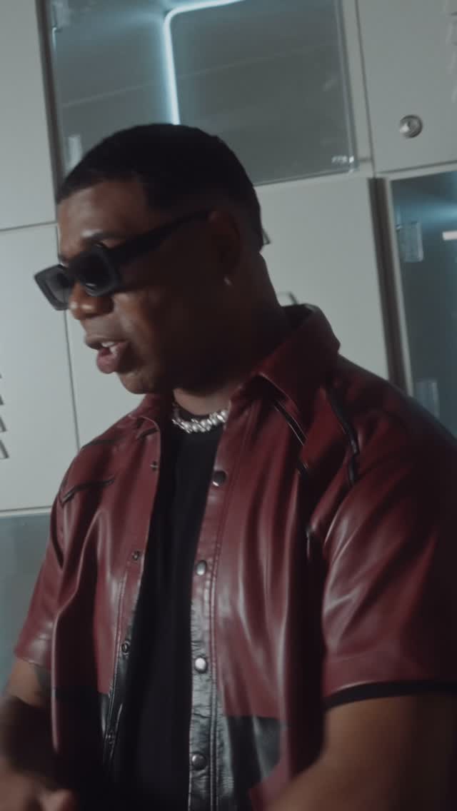 A frame from LMP's Instagram reel for “Locura”: Jheral in sunglasses and a dark-red leather shirt
