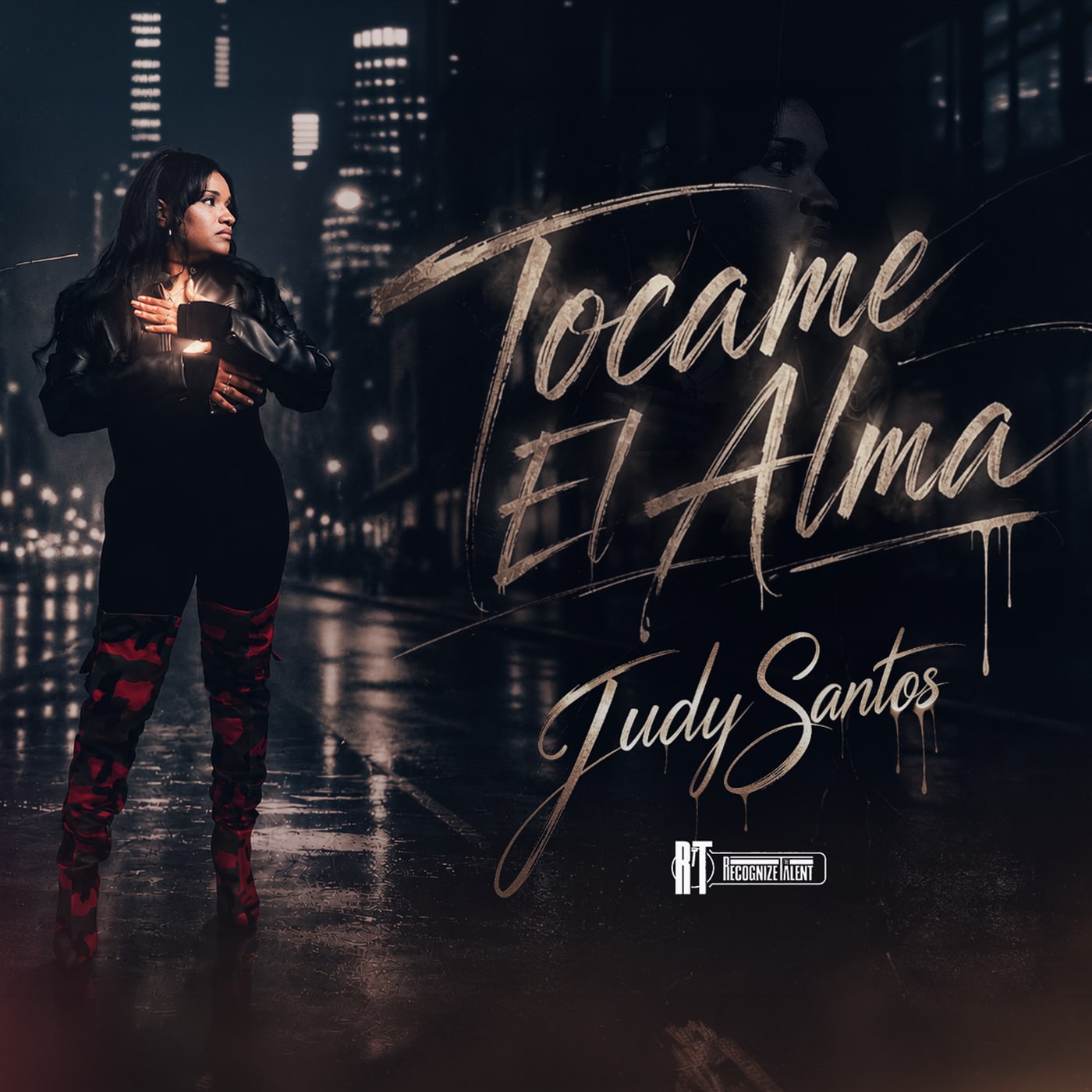 Judy Santos on a rainy city street at night on the cover art for “Tócame El Alma”